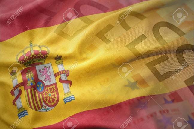 colorful waving national flag of spain on a euro money banknotes background. finance concept