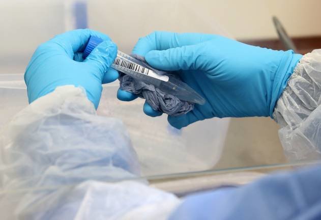 A technician cleans test tubes containing live samples during the opening of the new COVID-19 testing lab at Queen Elizabeth University Hospital, amid the coronavirus disease epidemic in Glasgow, Britain April 22, 2020. Andrew Milligan/Pool via REUTERS