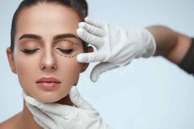 Facial Treatment. Portrait Of Beautiful Sexy Woman With Closed Eyes And Black Surgical Lines On Skin. Closeup Of Hands Touching Young Female Face. Plastic Surgery Concept. High Resolution