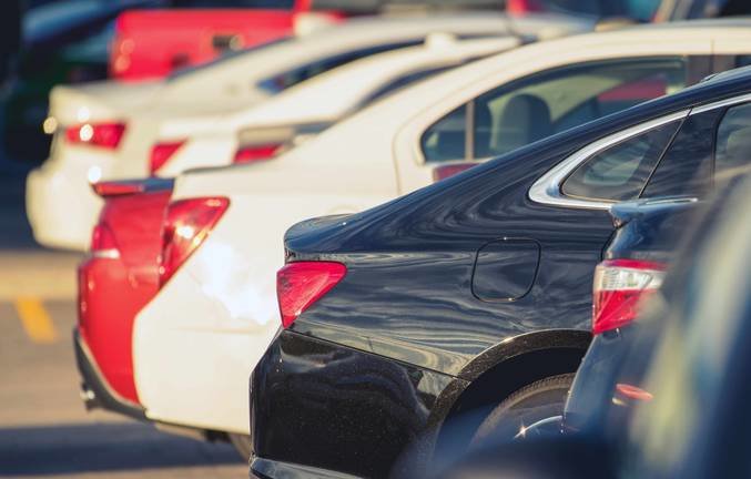Parking Full of Modern Cars:parking,car,auto,vehicle,parked,new,modern,dealer,dealership,automotive,transportation,transport,outdoor,rear,row,selective focus,place,traffic