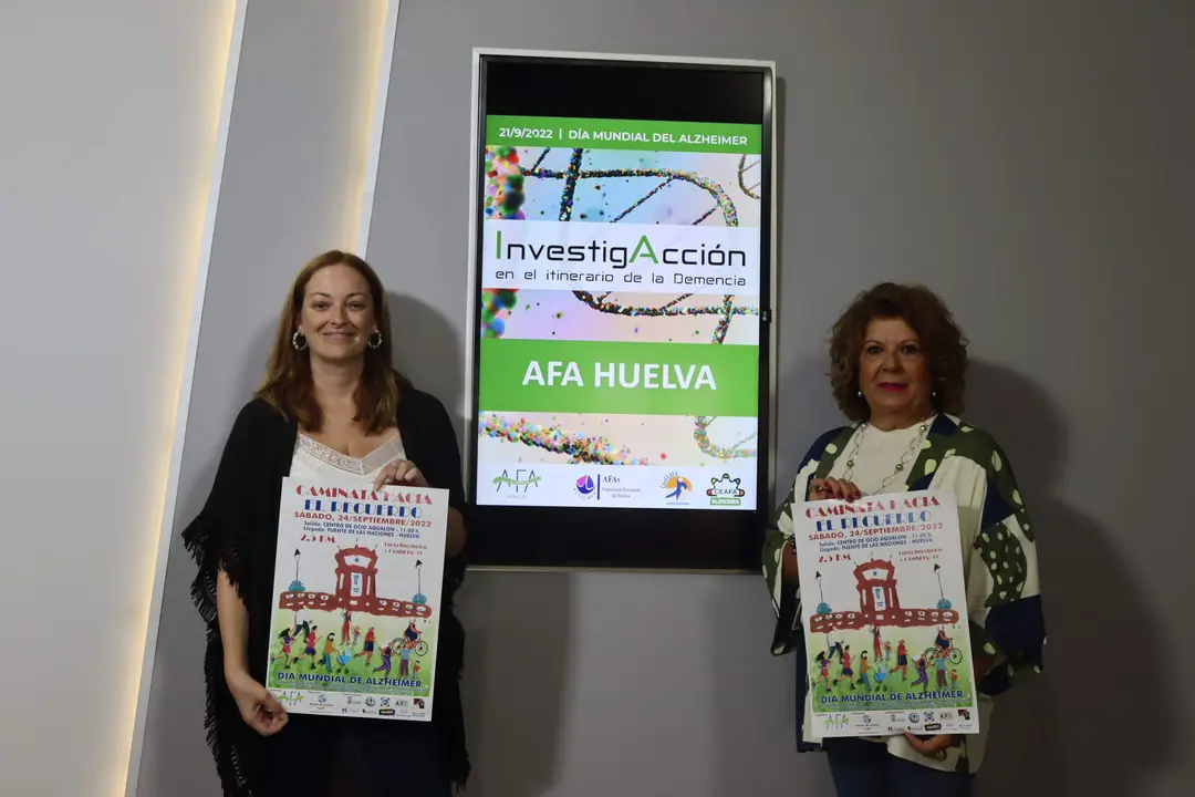 Cartel con el que posan representantes del Ayuntamiento de Huelva y AFA