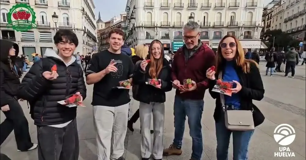 UPA Huelva reparte las tarrinas de fresas en la Puerta del Sol.
