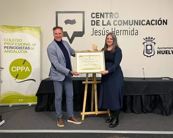 Raquel recibe el premio de manos del presidente del Colegio en Huelva