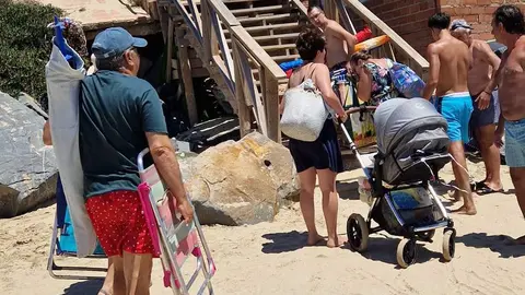 Bañistas en un acceso con muchos defectos