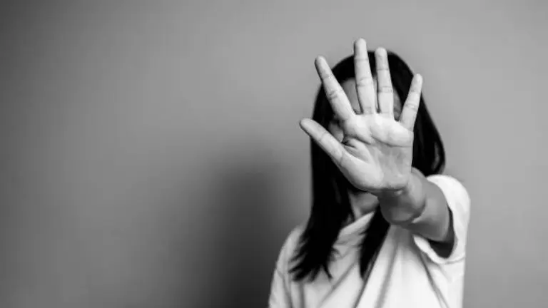 woman raised her hand for dissuade, campaign stop violence against women. Asian woman raised her hand for dissuade with copy space, black and white color