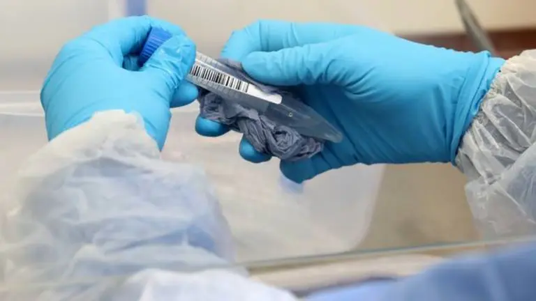 A technician cleans test tubes containing live samples during the opening of the new COVID-19 testing lab at Queen Elizabeth University Hospital, amid the coronavirus disease epidemic in Glasgow, Britain April 22, 2020. Andrew Milligan/Pool via REUTERS