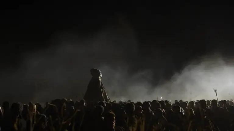 People gather around a statue of the Virgen del Rocio covered during the El Rocio Chico, Romeria pilgrimage, a traditional pilgrimage, in Huelva on August 20, 2019. Once every seven years the Virgen del Rocio travels at night from El Rocio to Almonte during your traditional transfer. (Photo by Cristina Quicler / AFP)