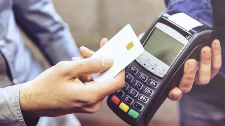 Customer and cashier in a store paying using a contactless card