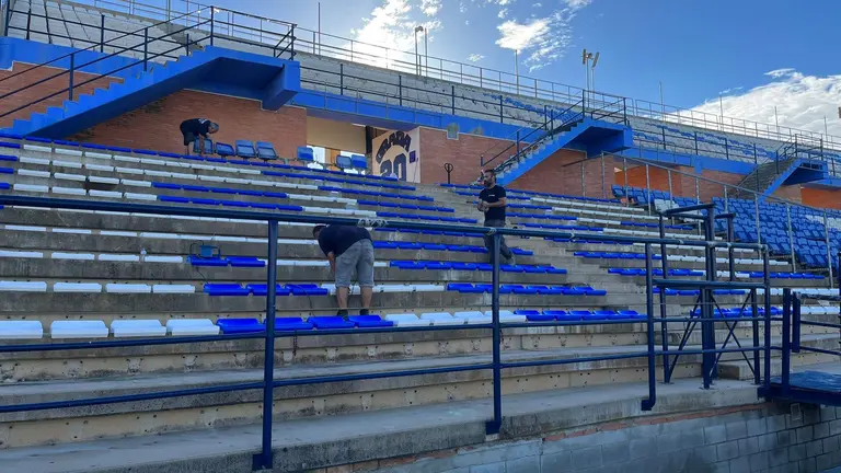 Operarios cambiando los asientos de la Grada de Animación del Recre.