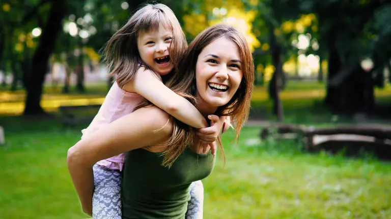 Little girl with special needs enjoy spending time with mother in nature