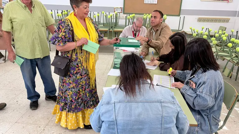 Una mujer vestida con su traje de gitana, ejerciendo su derecho al voto en Beas.